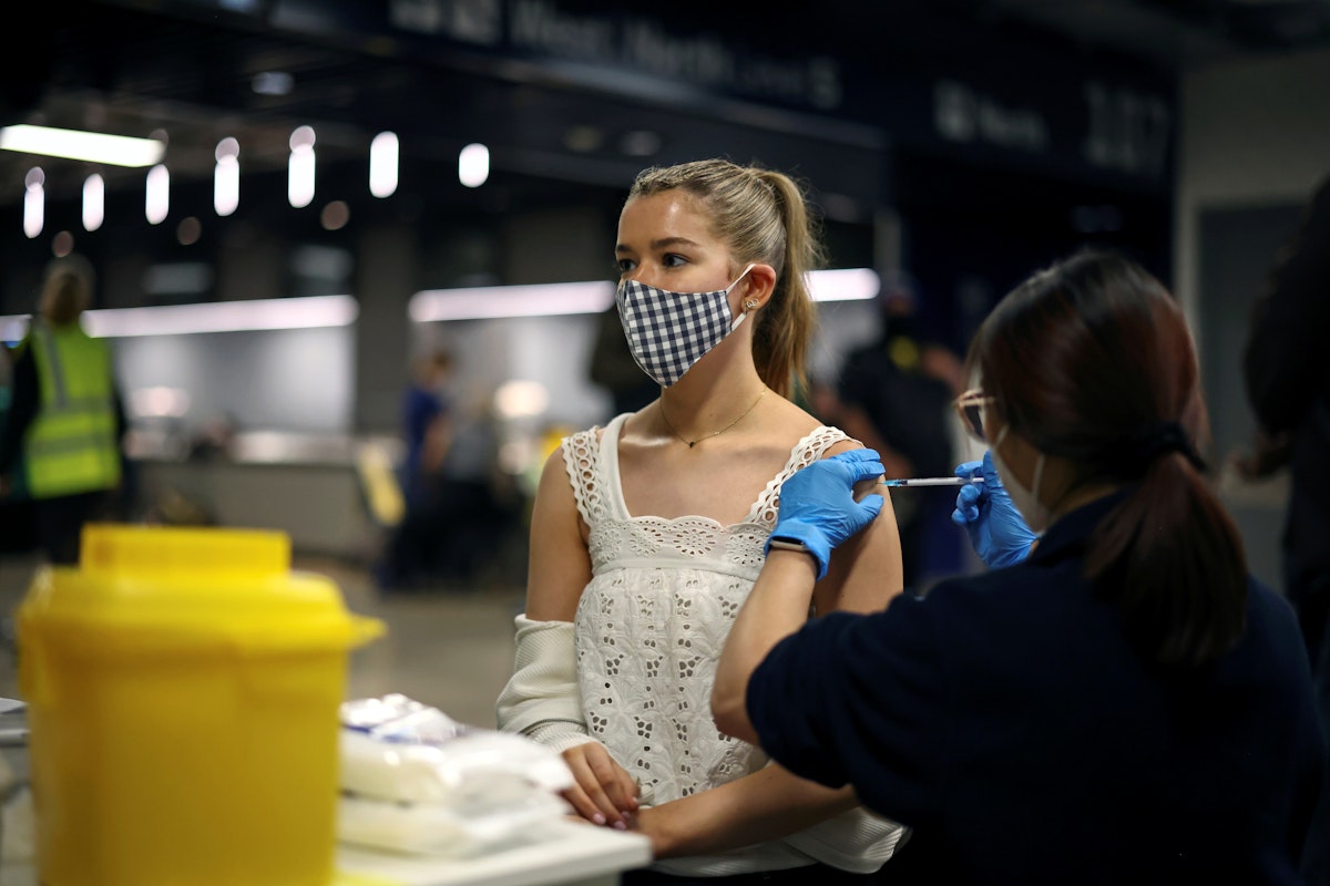 شابة تتلقّى جرعة من لقاح مضاد لفيروس كورونا في لندن، 20 يونيو 2021 - REUTERS