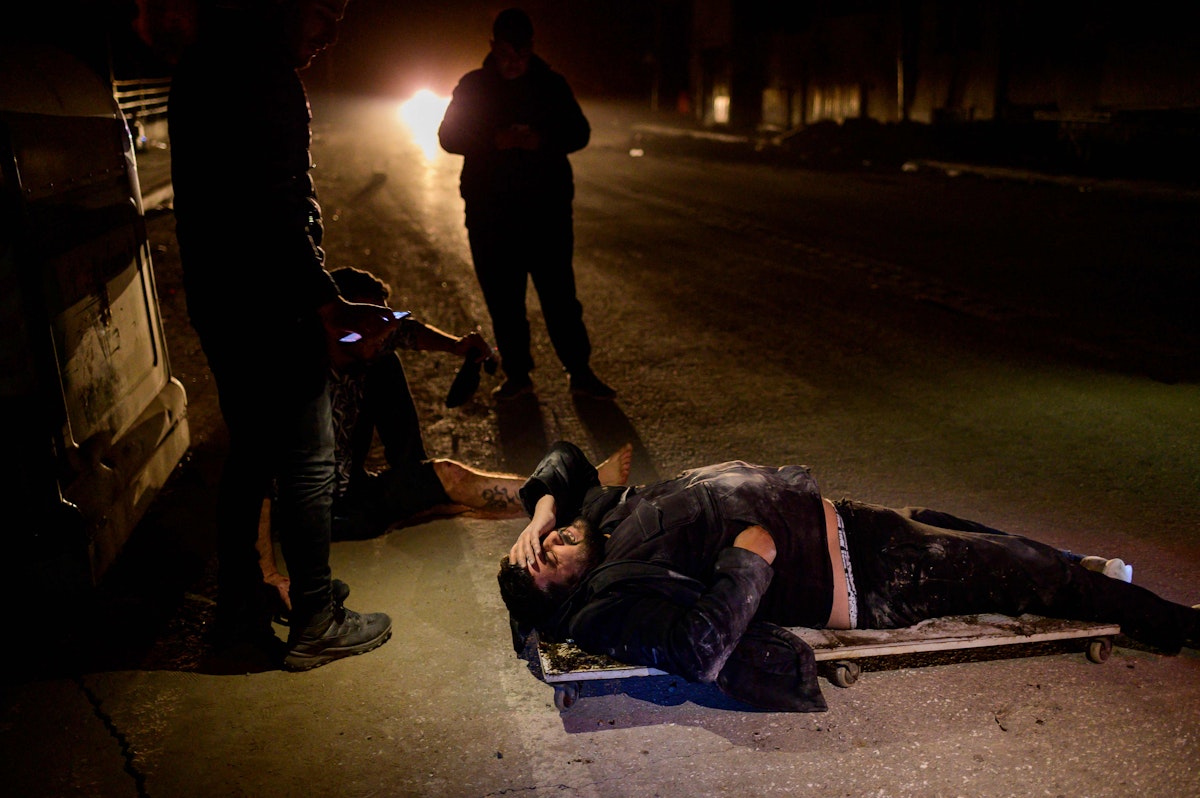 Two injured people lie on the ground after a 6.4-magnitude quake hit the Hatay province in southern Turkey, on February 20, 2023. - A 6.4-magnitude earthquake was recorded February 20 in Turkey's southern province of Hatay, the hardest hit by a February 6 tremor which left more than 41,000 dead in the country, the disaster response agency AFAD said. (Photo by Yasin AKGUL / AFP) - AFP